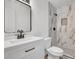 Modern bathroom with marble tile in the shower and vanity with black fixtures at 8833 E Bourne E Dr, Jonesboro, GA 30238