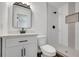 Updated bathroom features modern vanity, framed mirror and stand-up shower with decorative tiling at 8833 E Bourne E Dr, Jonesboro, GA 30238