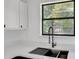 Modern kitchen features stylish sink, quartz countertops, stainless steel dishwasher and dark-toned cabinetry at 8833 E Bourne E Dr, Jonesboro, GA 30238