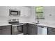 Modern kitchen featuring stainless steel appliances, shaker cabinets and granite countertops at 8833 E Bourne E Dr, Jonesboro, GA 30238