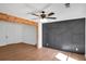 Open-concept living room features wood beam accents, ceiling fan and designer feature wall at 8833 E Bourne E Dr, Jonesboro, GA 30238