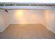 A large, finished basement is ready for customization with track lighting and laminate flooring at 172 Haynes Sw St # 107, Atlanta, GA 30313