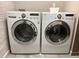 Modern laundry room featuring side-by-side washer and dryer with chrome accents at 172 Haynes Sw St # 107, Atlanta, GA 30313