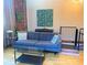Modern living room with a comfortable blue sofa, exposed brick, and contemporary decor at 172 Haynes Sw St # 107, Atlanta, GA 30313