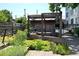 Charming outdoor space with a wooden pergola, planters and manicured landscaping at 172 Haynes Sw St # 107, Atlanta, GA 30313