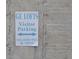 Clear visitor parking sign with directional arrows at GE Lofts; violators will be towed at 172 Haynes Sw St # 107, Atlanta, GA 30313