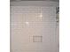 The shower stall is tiled with white subway tile and a convenient niche for toiletries at 172 Haynes Sw St # 107, Atlanta, GA 30313