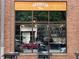 Storefront with large windows advertising 'Brooklyn Tea' with tables and chairs visible in the foreground at 172 Haynes Sw St # 107, Atlanta, GA 30313