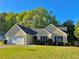 Charming home featuring a manicured lawn, a two-car garage, and a well-maintained landscape at 2536 Caray Ne Ct, Lawrenceville, GA 30043