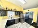 Bright kitchen with stainless steel appliances, black cabinets, and a view into the dining area at 2536 Caray Ne Ct, Lawrenceville, GA 30043