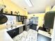 Well-lit kitchen with stainless steel appliances and black cabinets next to the stainless steel refrigerator at 2536 Caray Ne Ct, Lawrenceville, GA 30043