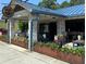 Charming Bluetop restaurant exterior with blue awning, brickwork, and inviting outdoor seating area at 5300 Peachtree Rd # 3601, Atlanta, GA 30341