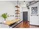 Hallway featuring a custom-built desk, shelving, hardwood floors, and modern industrial design at 5300 Peachtree Rd # 3601, Atlanta, GA 30341