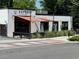 Hopstik Asian Brewpub exterior featuring industrial design, ample outdoor seating, and modern lighting at 5300 Peachtree Rd # 3601, Atlanta, GA 30341