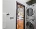 Modern laundry area with stacked washer and dryer and a glimpse of the hardwood flooring in the open space at 5300 Peachtree Rd # 3601, Atlanta, GA 30341