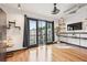 Bright living space features hardwood floors, balcony access, and a modern shelving unit at 5300 Peachtree Rd # 3601, Atlanta, GA 30341