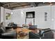 Living room with black leather sofas, hardwood floors and large screen TV at 5300 Peachtree Rd # 3601, Atlanta, GA 30341