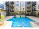 Community pool with a water feature, lounge chairs, and well-maintained landscaping for outdoor enjoyment at 5300 Peachtree Rd # 3601, Atlanta, GA 30341