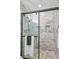 Modern shower with marble tile, glass enclosure, and built-in niche for toiletries at 5300 Peachtree Rd # 3601, Atlanta, GA 30341