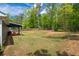Large backyard with a covered patio and wooden fence at 60 Water Oak Trl, Covington, GA 30014