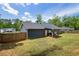 A spacious backyard with a wooden fence and covered patio at 60 Water Oak Trl, Covington, GA 30014