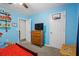 A vibrant bedroom features built-in shelves, a TV, and a door for private bathroom entry at 60 Water Oak Trl, Covington, GA 30014