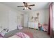 A playful bedroom designed for a with soft pinks, plush rug, and playful decor at 60 Water Oak Trl, Covington, GA 30014