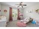 A charming bedroom designed for a with soft pinks, plush rug, and playful decor at 60 Water Oak Trl, Covington, GA 30014