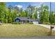 Charming blue home with a well-manicured lawn and attached garage, perfect for suburban living at 60 Water Oak Trl, Covington, GA 30014