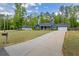 Charming blue home with a well-manicured lawn, long driveway, and a detached garage at 60 Water Oak Trl, Covington, GA 30014