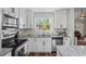 Modern kitchen with granite countertops, stainless steel appliances, and bright natural lighting at 60 Water Oak Trl, Covington, GA 30014