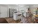 Eat-in kitchen features an island with seating, stainless steel appliances, and white cabinets at 60 Water Oak Trl, Covington, GA 30014