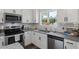 Modern kitchen with granite countertops, stainless steel appliances, and subway tile backsplash at 60 Water Oak Trl, Covington, GA 30014