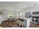 Eat-in kitchen features an island, stainless steel appliances, white cabinets, and ample countertop space at 60 Water Oak Trl, Covington, GA 30014