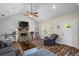 Bright living room boasts a stone fireplace, vaulted ceiling, and wood-look flooring at 60 Water Oak Trl, Covington, GA 30014