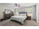 Spacious main bedroom with soft light, stylish furniture, carpet flooring and multiple windows at 60 Water Oak Trl, Covington, GA 30014