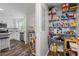 Organized walk-in pantry with ample shelving and an adjacent kitchen space at 60 Water Oak Trl, Covington, GA 30014