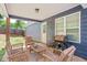 The covered patio features an outdoor seating and grill at 60 Water Oak Trl, Covington, GA 30014
