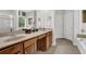 Bathroom showcasing a double vanity, tile floors, and a spacious layout at 1076 Firethorne Pass, Cumming, GA 30040