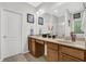 Bathroom featuring a double vanity, separate shower, and abundant natural light at 1076 Firethorne Pass, Cumming, GA 30040