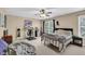 Comfortable bedroom featuring a ceiling fan, a stylish desk, and a cozy bed at 1076 Firethorne Pass, Cumming, GA 30040