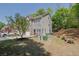 Side view of a two-story townhome with brick facade and well-maintained lawn and landscaping at 1076 Firethorne Pass, Cumming, GA 30040