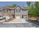Charming townhome featuring a brick facade, attached garage, and well-manicured landscaping at 1076 Firethorne Pass, Cumming, GA 30040