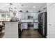Well-appointed kitchen with stainless steel appliances, dark countertops, and modern cabinets at 1076 Firethorne Pass, Cumming, GA 30040