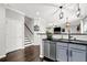 Bright kitchen featuring an island with seating, stainless steel appliances, and modern finishes at 1076 Firethorne Pass, Cumming, GA 30040
