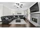 Cozy living room with stone fireplace, hardwood floors, and a comfortable sectional sofa at 1076 Firethorne Pass, Cumming, GA 30040