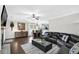 Open-concept living room featuring hardwood floors, fireplace, and seamless flow into the dining area at 1076 Firethorne Pass, Cumming, GA 30040