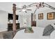Spacious main bedroom featuring a four-poster bed, dark furniture, and wood floors at 1076 Firethorne Pass, Cumming, GA 30040