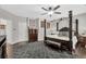 Main bedroom with dark furniture, hardwood floors, ceiling fan, and a comfortable bed at 1076 Firethorne Pass, Cumming, GA 30040
