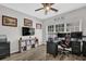 Home office with dual monitors, comfortable seating, and plenty of natural light at 1076 Firethorne Pass, Cumming, GA 30040